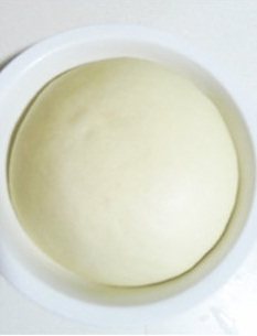咸蛋黄花卷 ,盖保鲜膜于温暖处放酵至二倍大；