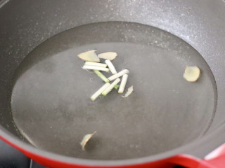 藤椒茼蒿肉片,锅中倒入适量清水，放入姜片和葱段，倒入剩下的1勺料酒。