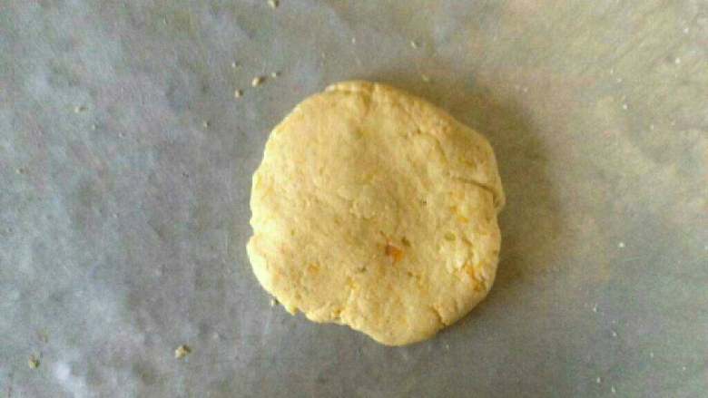 芝麻花生馅南瓜饼,取一个小团，揉成圆，再压扁成圆形。
