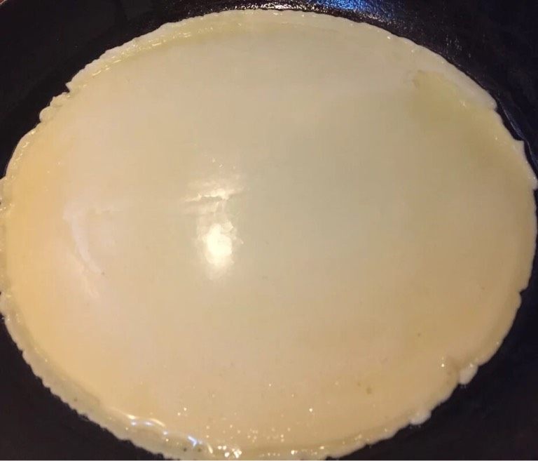 火腿鸡蛋卷,如图平底锅刷油，油热用勺子盛起面糊垂直倒入平底锅中心，快速晃动平底锅，使其成为一个圆饼。一面金黄翻至另一面