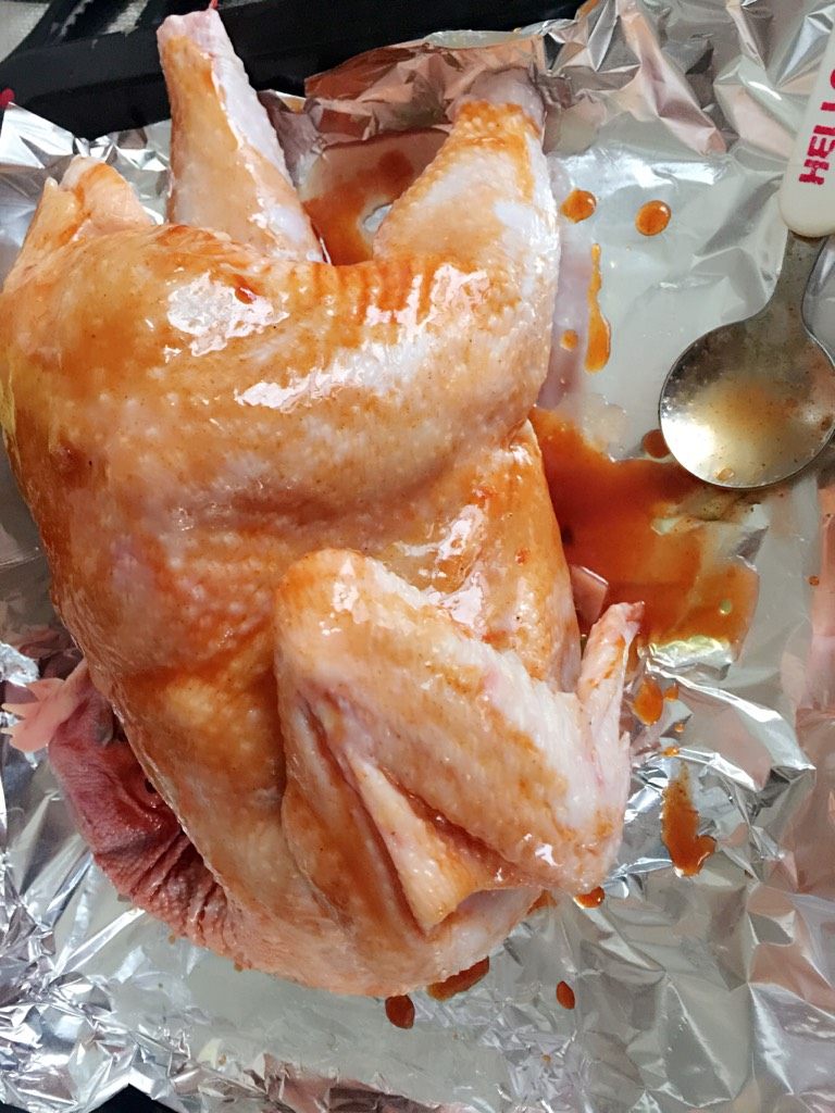 烤全鸡,如图，把酱汁均匀的涂抹在鸡上，烤盘放好锡纸，预热