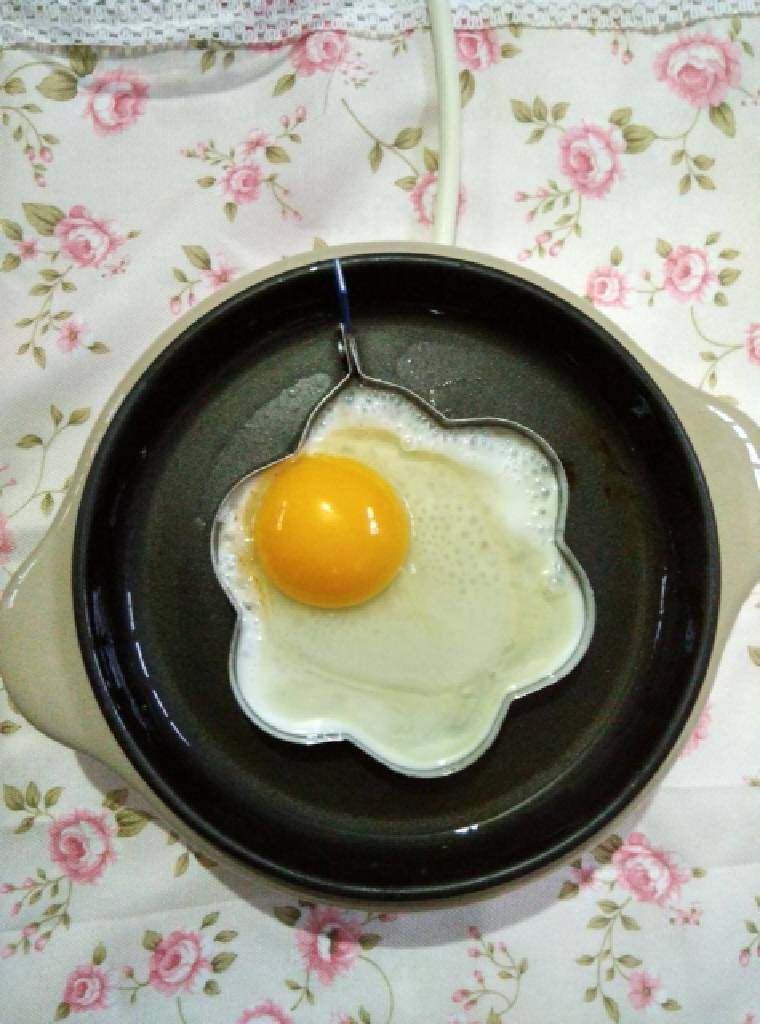 煎花型土鸡蛋,磕破土鸡蛋，放入模具内。