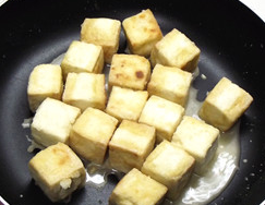 焦溜豆腐,用小火把豆腐四个面都煎至金黄色盛出备用。