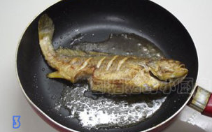 干烧黄鱼,平底锅加油烧热，放入黄花鱼用小火煎至两面金黄。