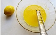 酸奶柠檬中空戚风蛋糕 ,用工具将柠檬的屑取出，放到蛋黄液中。