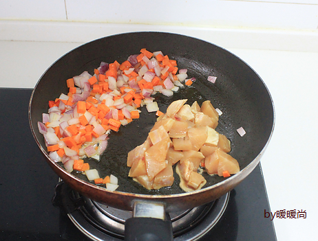 咖喱鸡肉炊饭,将洋葱和胡萝卜拨到一边，下鸡胸肉翻炒至变色。
