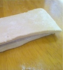 腊八面,撒足量面粉，切成10厘米宽，叠在一起