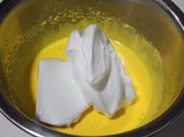 榴莲芝士慕斯蛋糕,取1/2蛋白加入蛋黄中翻拌均匀