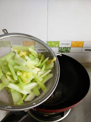 酱丁芹菜炒虾仁,锅里加少许的油，将焯好的芹菜下锅爆炒。