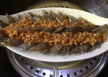 蒜蓉粉丝开片虾 ,将调好味的蒜蓉(连油）均匀的铺于虾上；