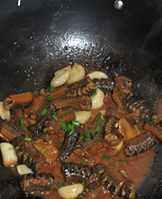 酱烧黄鳝,盖上盖子焖煮约10分钟后，开盖收汁撒点白胡椒粉和葱花即可出锅。
