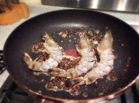 新加坡黑椒虾,加入虾翻炒，直到熟。把炒好的酱料，摆盘后放在虾的上面