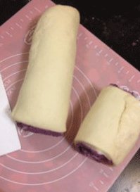 紫薯面包 ,用塑料刮板将面团平均分割成10份，放入纸模中，轻轻将面团压扁，放温暖湿润处进行最后发酵