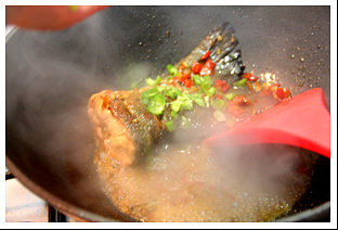 香茅剁椒三文鱼尾,待鱼8成熟时放入青椒丁，加入小量温水，焖至熟且入味。撒上鸡粉出锅。