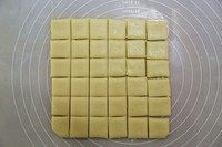 牛奶方块小饼干,用刀切割成四边整齐的四方形，然后再切成方形小块。