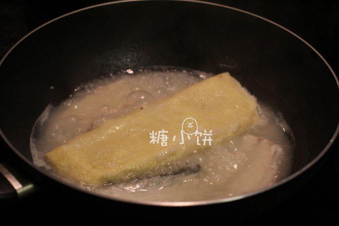 富贵庆余年,焯水过后的鱼骨加到羊肉汤中煮开，再加入步骤21的半成品鱼糕卷煮大约20分钟