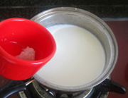 原味老酸奶,牛奶倒在小锅中，加入糖搅拌，小火煮至糖完全溶化。