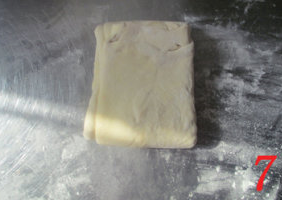 酥皮香肠卷,另一侧也向中间折成三折。包上保鲜膜，冷藏30分钟。