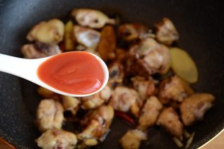 红焖栗子鸡,放入鸡块翻炒，淋入料酒和老抽翻炒上色，加1勺番茄沙司