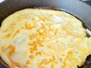 臘八豆拌面,雞蛋液均勻撒在鍋里煎至兩面微黃