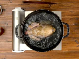 手撕椒麻鸡,将炖锅里的水烧开，放入腌制好的鸡