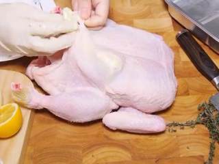 百里香烤鸡,用手指分开鸡胸部的皮和肉，把之前拌好的黄油塞进去，均匀的分布，剩下的涂抹鸡的全身