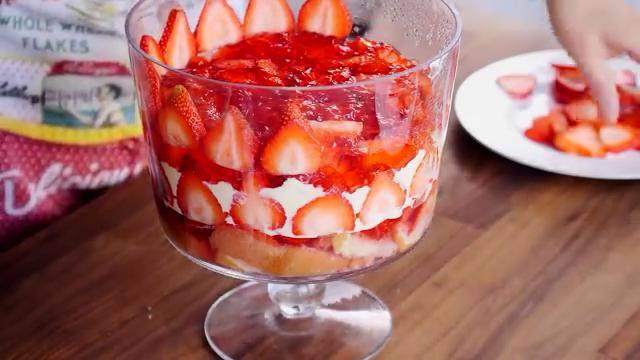 草莓布丁杯,用叉子叉碎冷藏过的果冻，倒在草莓上，再围一圈草莓片