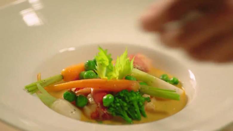 法式传统龙虾汤,虾肉、蔬菜等装盘，浇上汤汁，点缀香芹叶