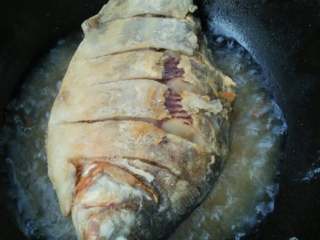 红烧白鲳鱼,锅里倒油烧热将鱼放入两面炸制金黄