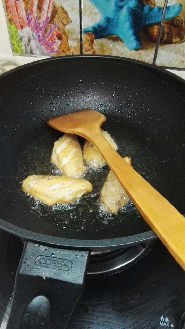 苹果鸡翅,油锅加热至8分热，调中火放入鸡翅，炸至两面变金黄即可，不需要炸熟