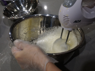红丝绒蛋糕卷,把糖分次加入蛋清，用电动打蛋器先低速打发蛋白，出现粗泡时用高速进行打发