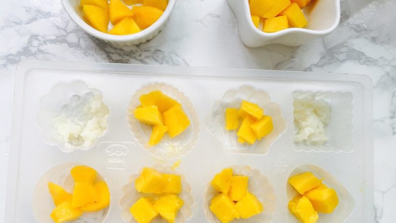 黄桃凉粉满足你对夏天的一切幻想,黄桃块，芒果块，酒酿米放入模具
