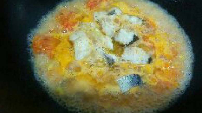 西红柿炖鱼,汁煮开后放入鱼块，盖上锅盖接着炖。