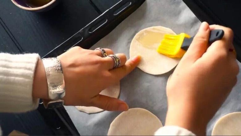 芝士海苔饼,饺子皮铺在烤盘中，刷上橄榄油。