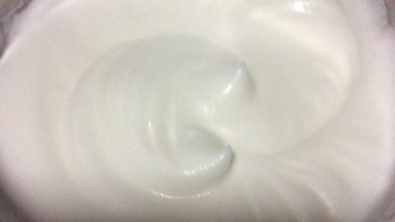 柠香西柚戚风蛋糕,继续中速打散，打至蛋抽抽出后，蛋峰的蛋白下垂，加入剩下的糖。