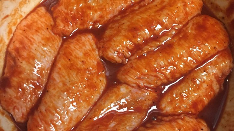 奥尔良烤鸡翅,把鸡翅放进佐料，佐料要刚好覆盖鸡翅表面，用手按摩挤压5分钟，拌匀，放入冰箱冷藏12到24个小时。