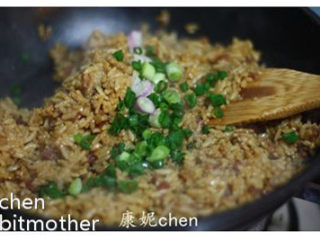 【酱油炒饭】,炒熟腊肠丁后倒入拌匀的米饭，翻炒均匀