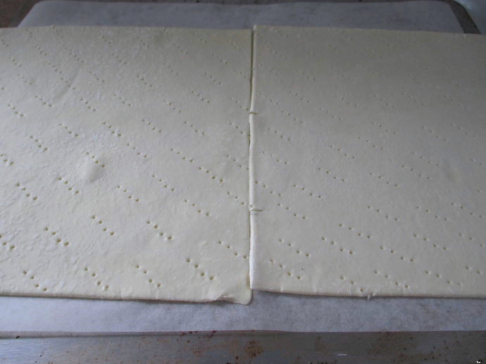 香草卡仕达方块——Vanilla Custard Squares ,解冻酥皮，把酥皮放在烤盘上，用叉子插许多洞洞