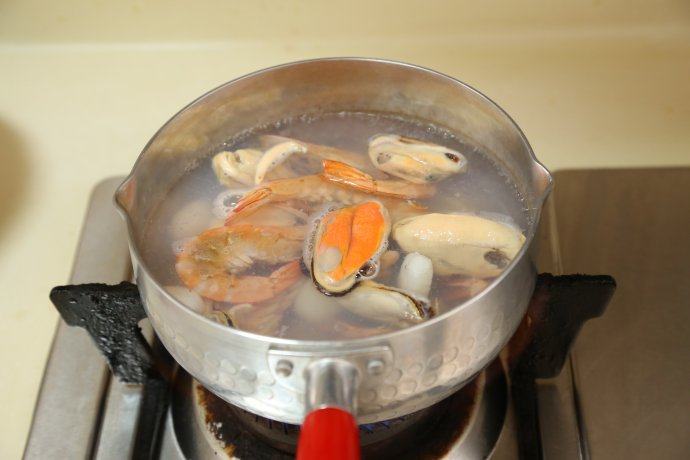 教你如何在家做一碗高颜值的［海鲜乌冬面］,做一锅开水，把海鲜煮熟。大概煮个2分钟即可。