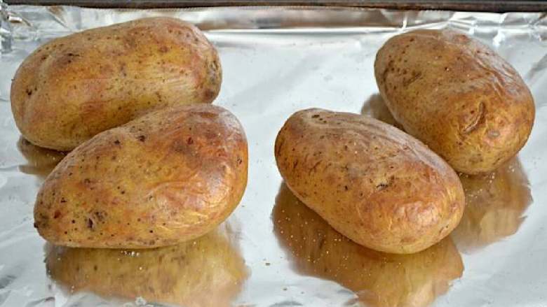 芝士烤土豆,烤盘盖上锡纸，将土豆放在烤板上，烤45分钟到一个小时，直到变软。