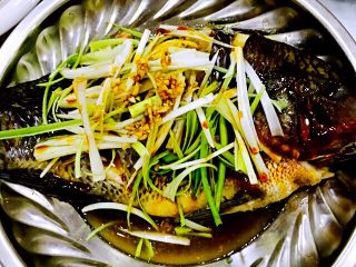 一锅出十菜,先将鱼盛出，撒葱姜蒜，淋入适量蒸鱼豉油。