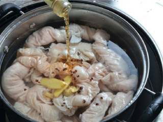 干煸肥肠,将肥肠放入冷水锅中，加入姜片、花椒、料酒，煮两个小时左右。