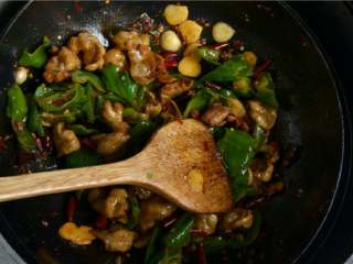 干煸肥肠,将煸炒过的肥肠和青椒倒入锅里一起翻炒均匀。