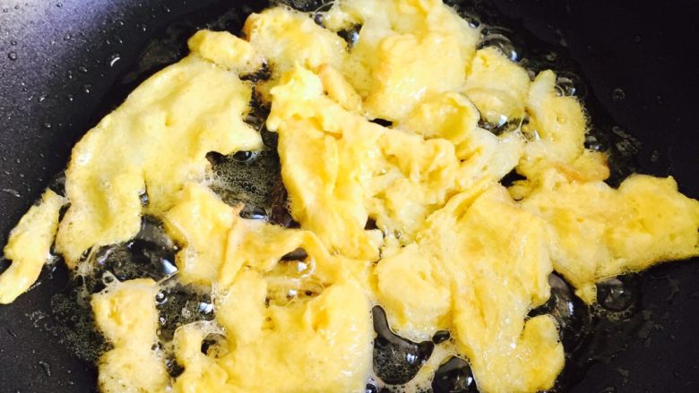 卷心菜胡萝卜鸡蛋炒粉丝#挑战鸡蛋的100种做法#,炒锅放入油加热，倒入鸡蛋液快速划散。然后装在碗里备用