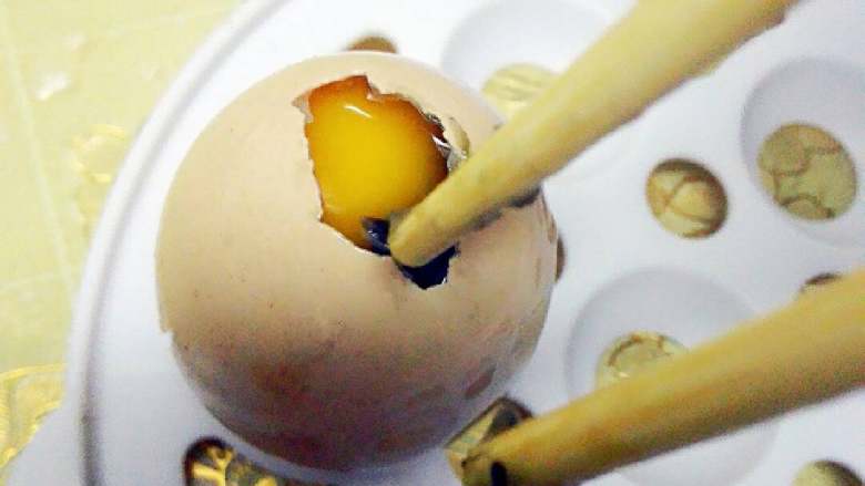 琥珀鸡蛋,将切成小粒的皮蛋用筷子逐渐塞入，注意用力不要太大，以免把蛋黄捅碎，小心哦