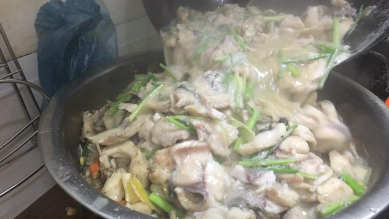 正宗湘菜 片片鱼火锅,看到鱼片煮熟了。在此尝一下味道。淡了就加盐。不淡就直接出锅。把鱼片倒入盛有鱼骨跟豆芽的大盆里。