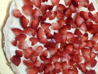 草莓奶油蛋糕,抹平后，重复做第9步骤，用打发好的奶油放草莓粒上抹平