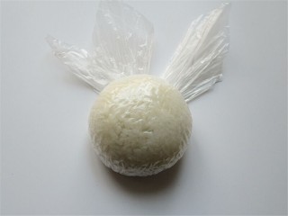 米菲兔杯子趣味餐,把米饭用保鲜膜握紧团起来，揉成一个球形饭团做头部主体部分