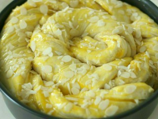 香草杏仁面包,二发发酵到8分满。表面刷蛋黄，撒杏仁片。