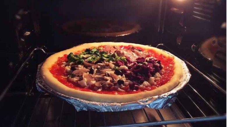 意式四季披萨,放入预热烤箱180度烤5分钟，表面再撒上奶酪碎烘烤至熟即可。约用时20分钟左右。